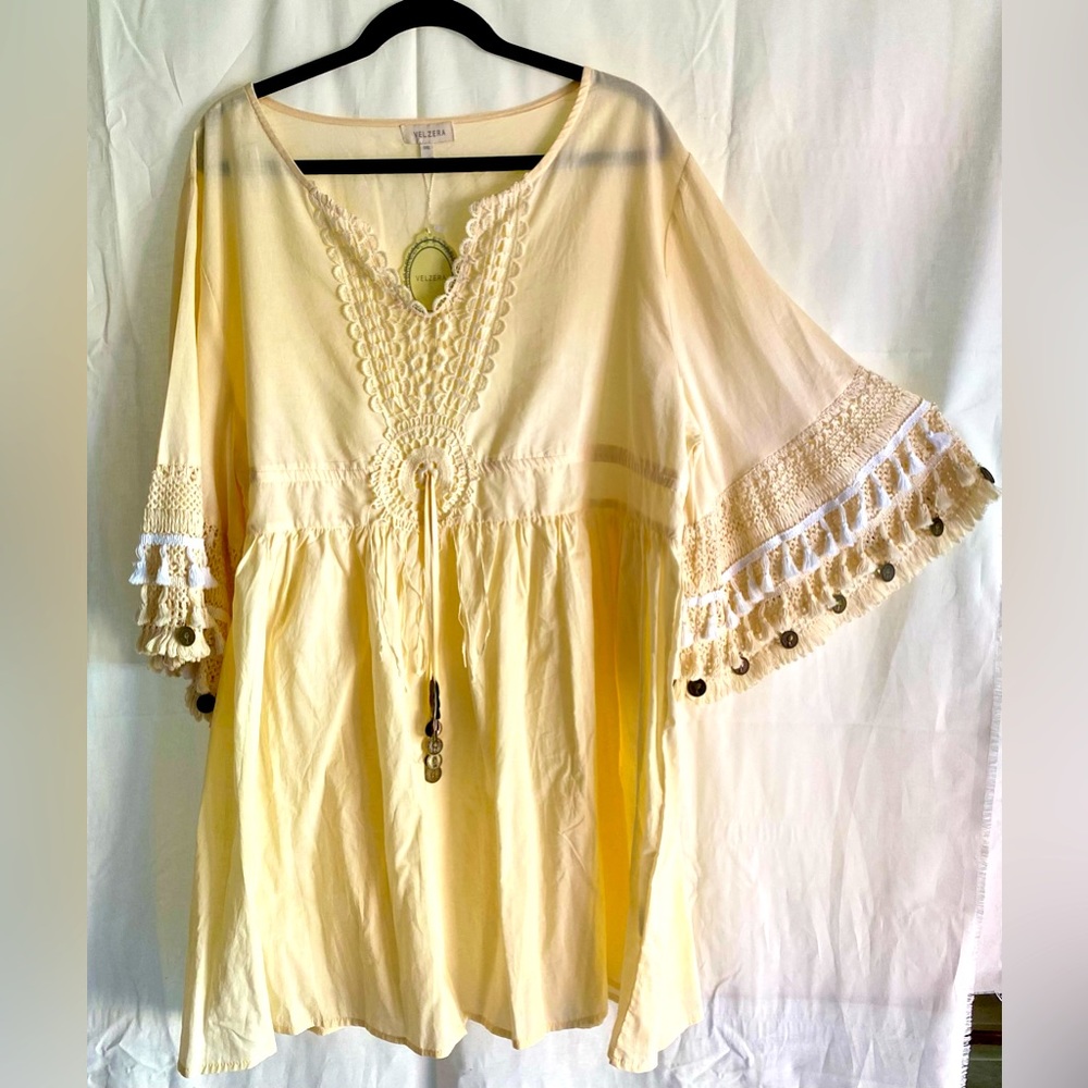 White tunic with fringe sleeves and coin embellishments